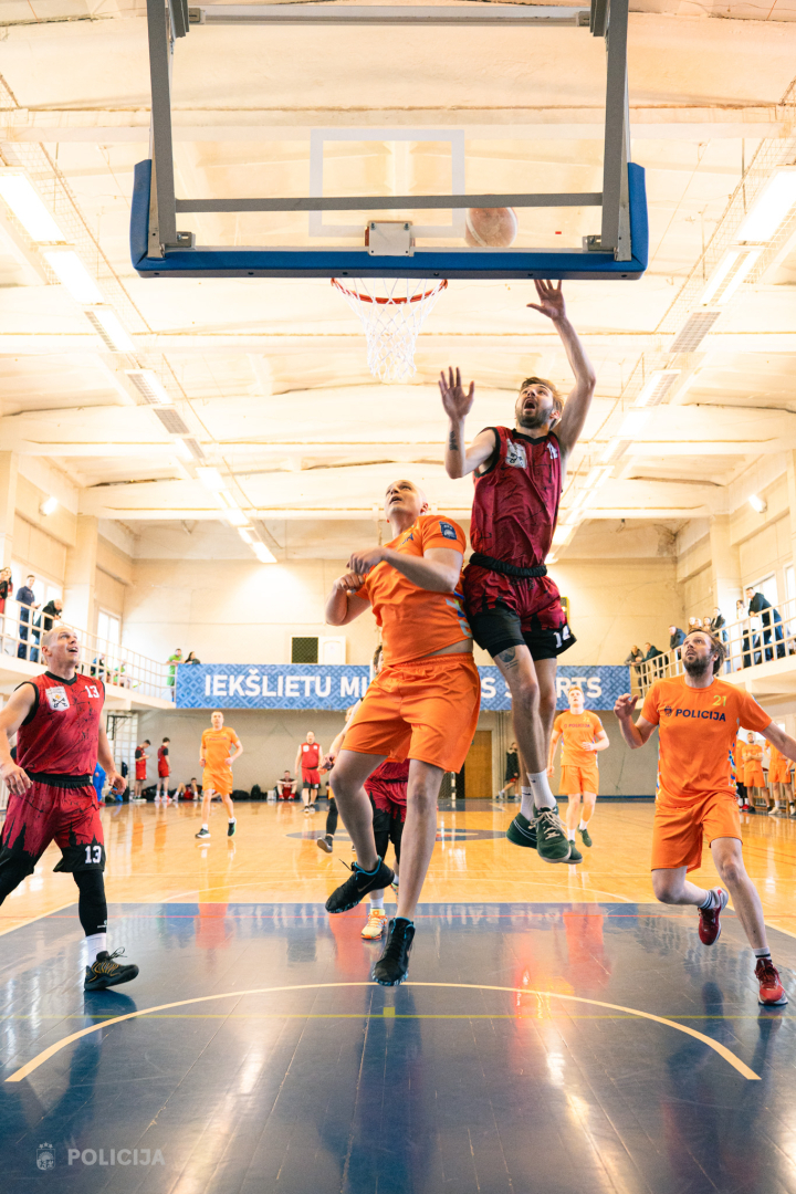 Komandas spēlētāji cīnās par punktu gūšanu zem groza